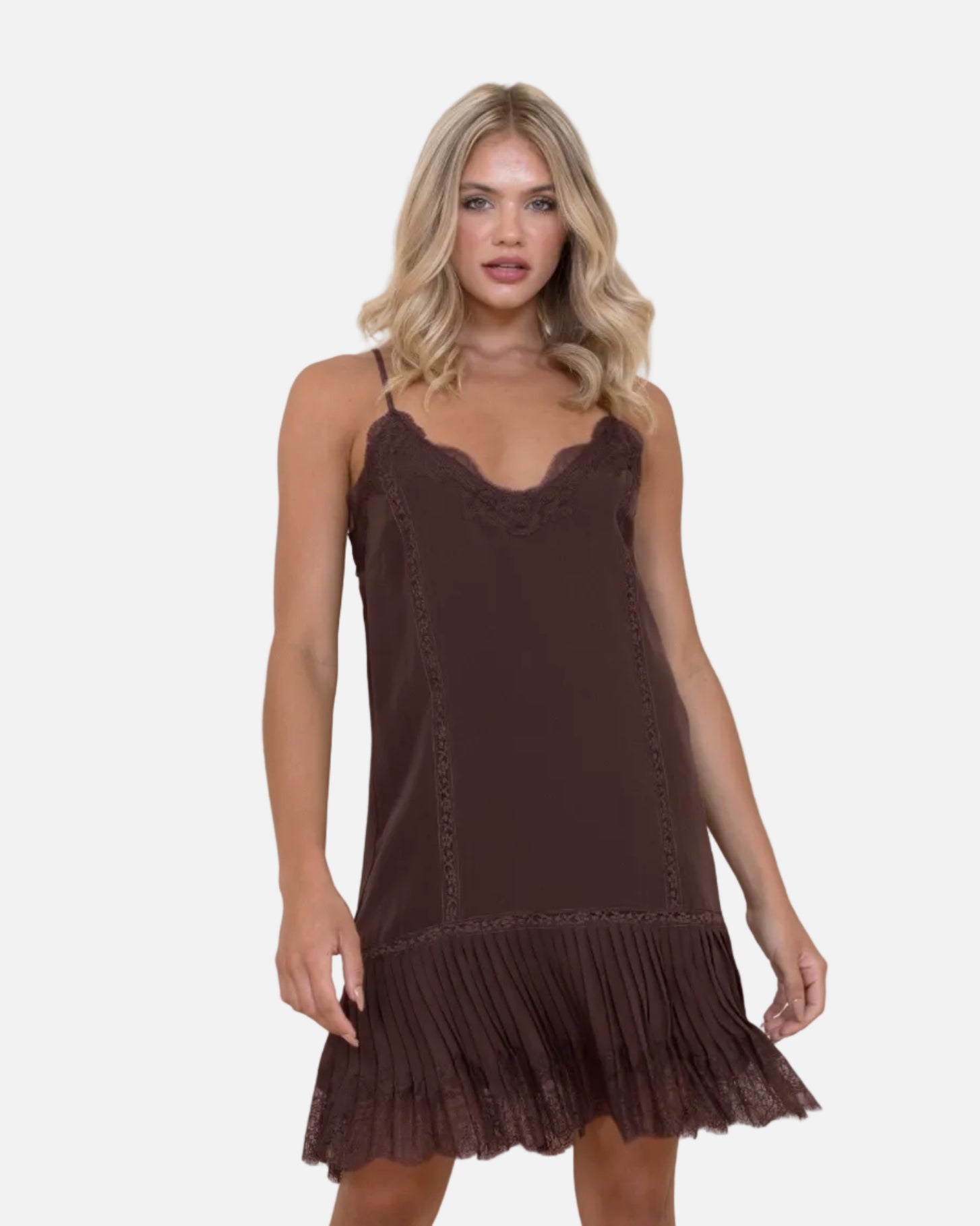 Woman wearing a brown slip dress with fringe hem against a white background